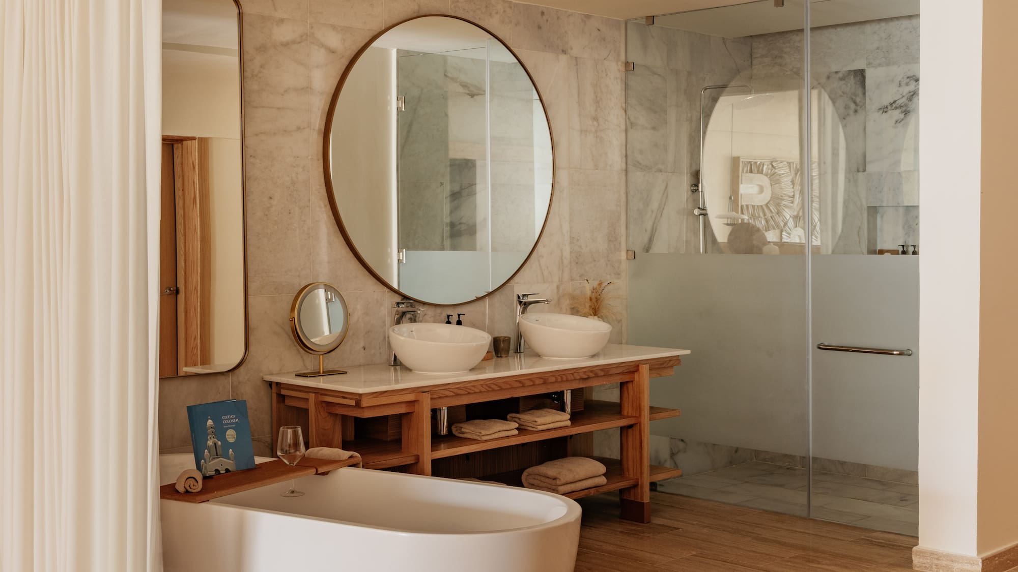 Luxurious modern bathroom with freestanding tub, double vanity, glass shower.