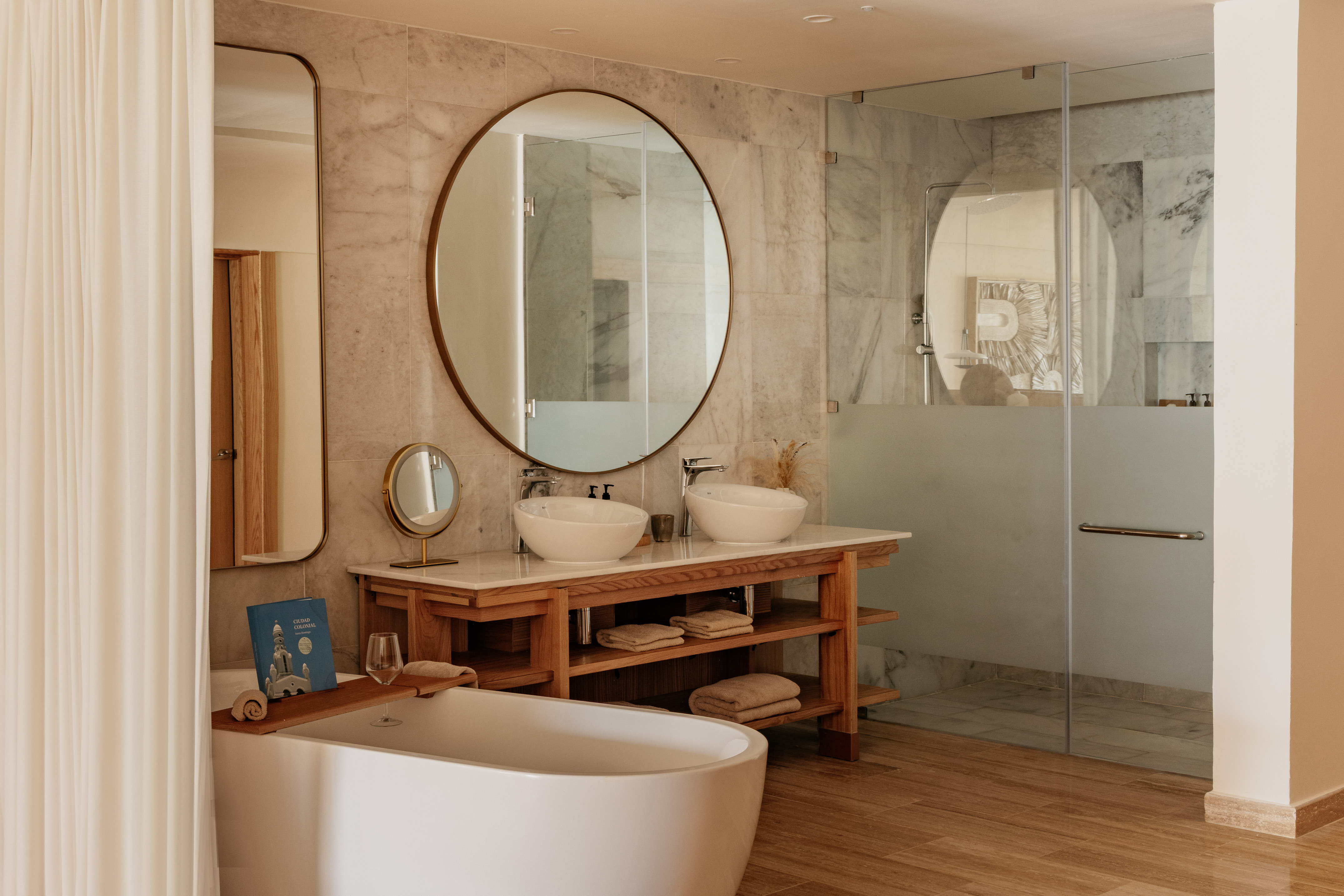 Luxurious modern bathroom with freestanding tub, double vanity, glass shower.
