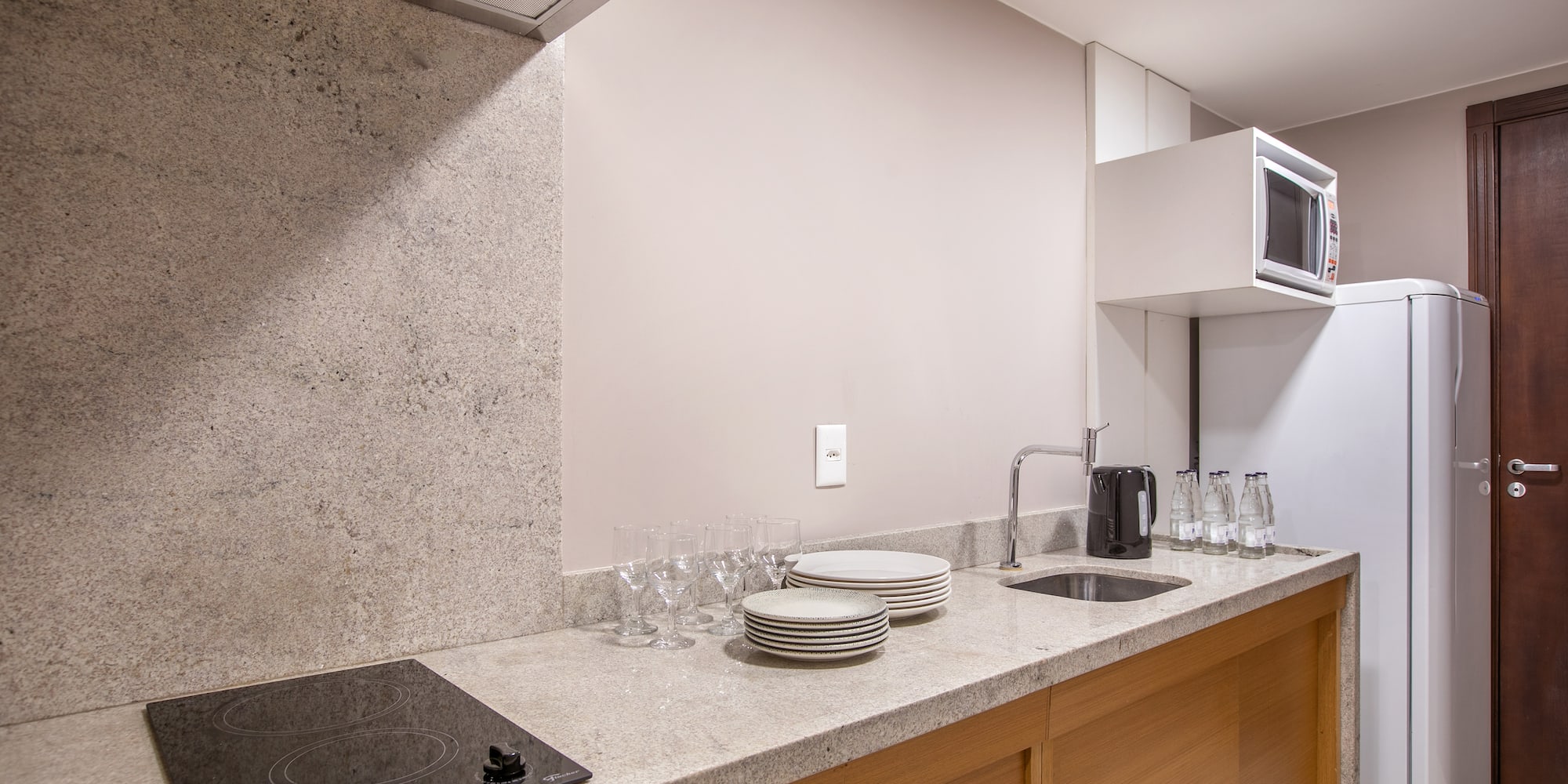 a kitchen with a stove and plates on the counter