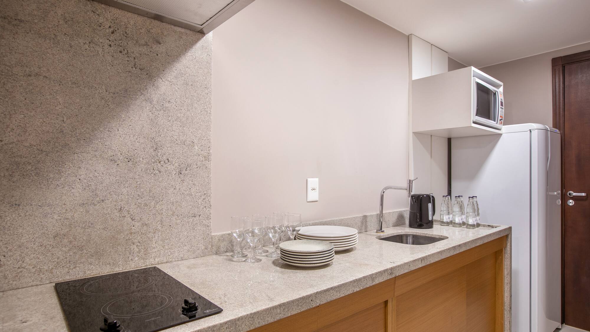 a kitchen with a stove and plates on the counter