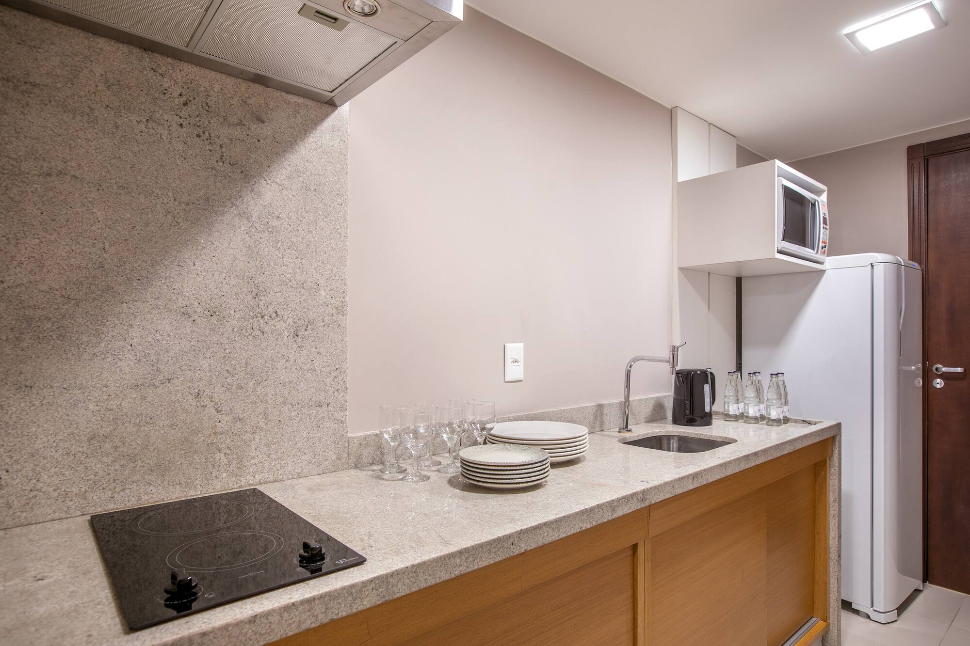 a kitchen with a stove and plates on the counter
