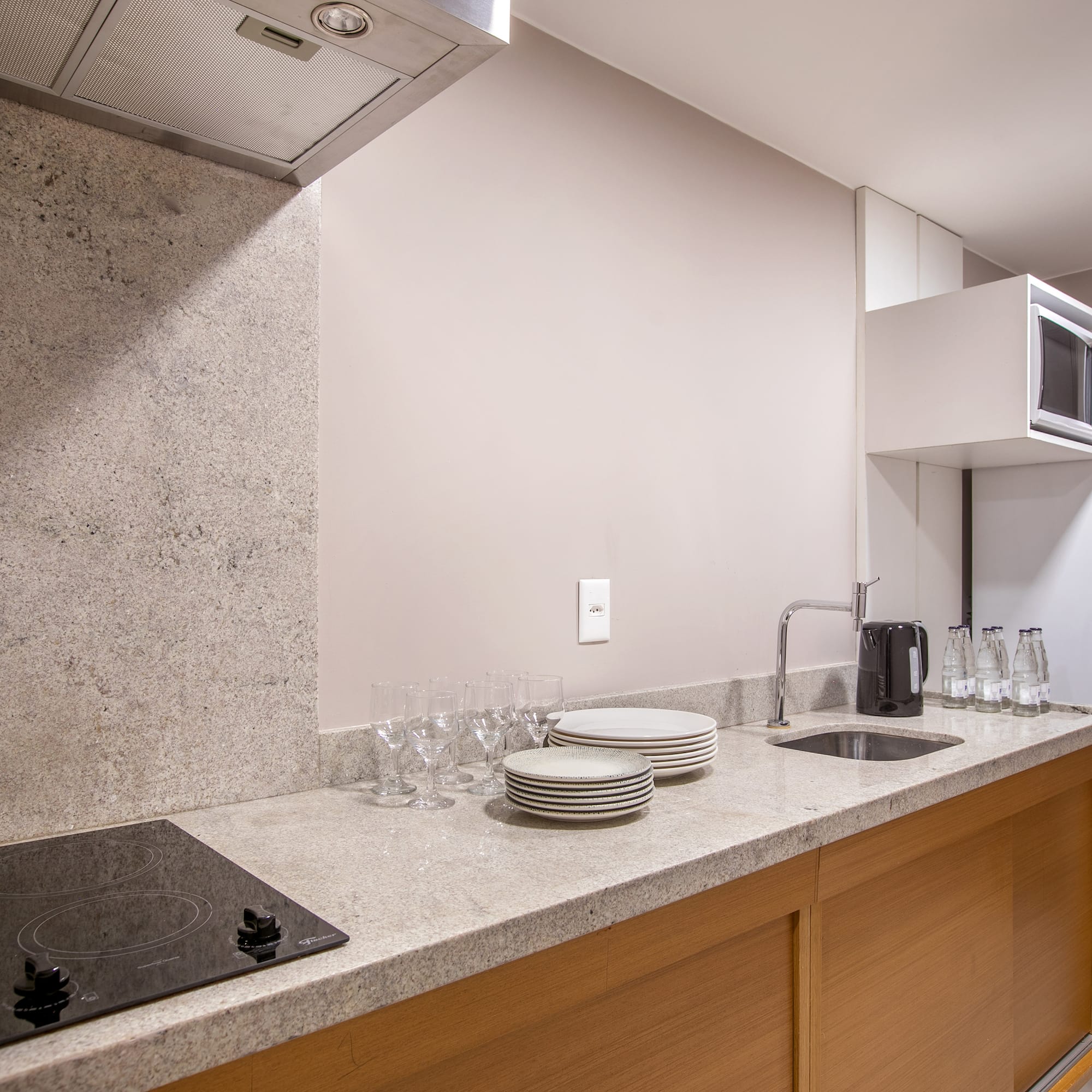 a kitchen with a stove and plates on the counter