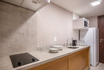 a kitchen with a stove and plates on the counter