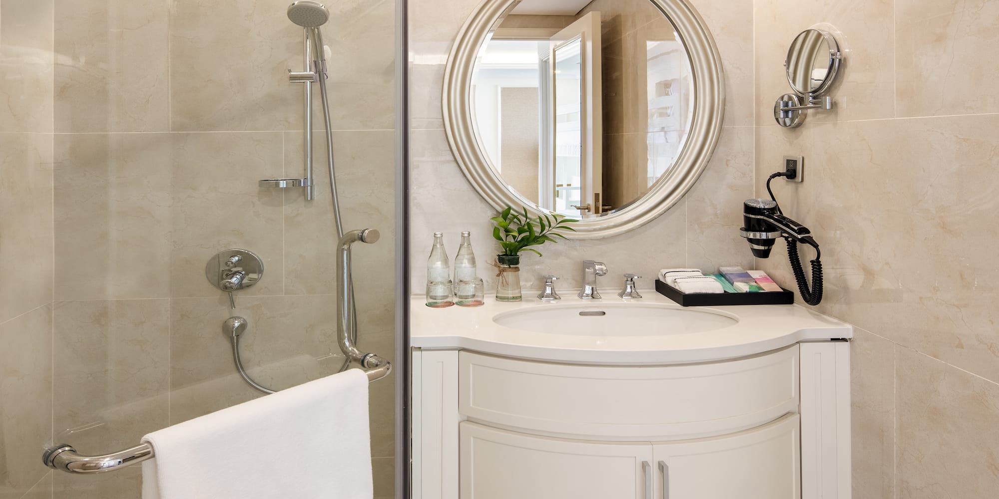 a bathroom with a round mirror and shower