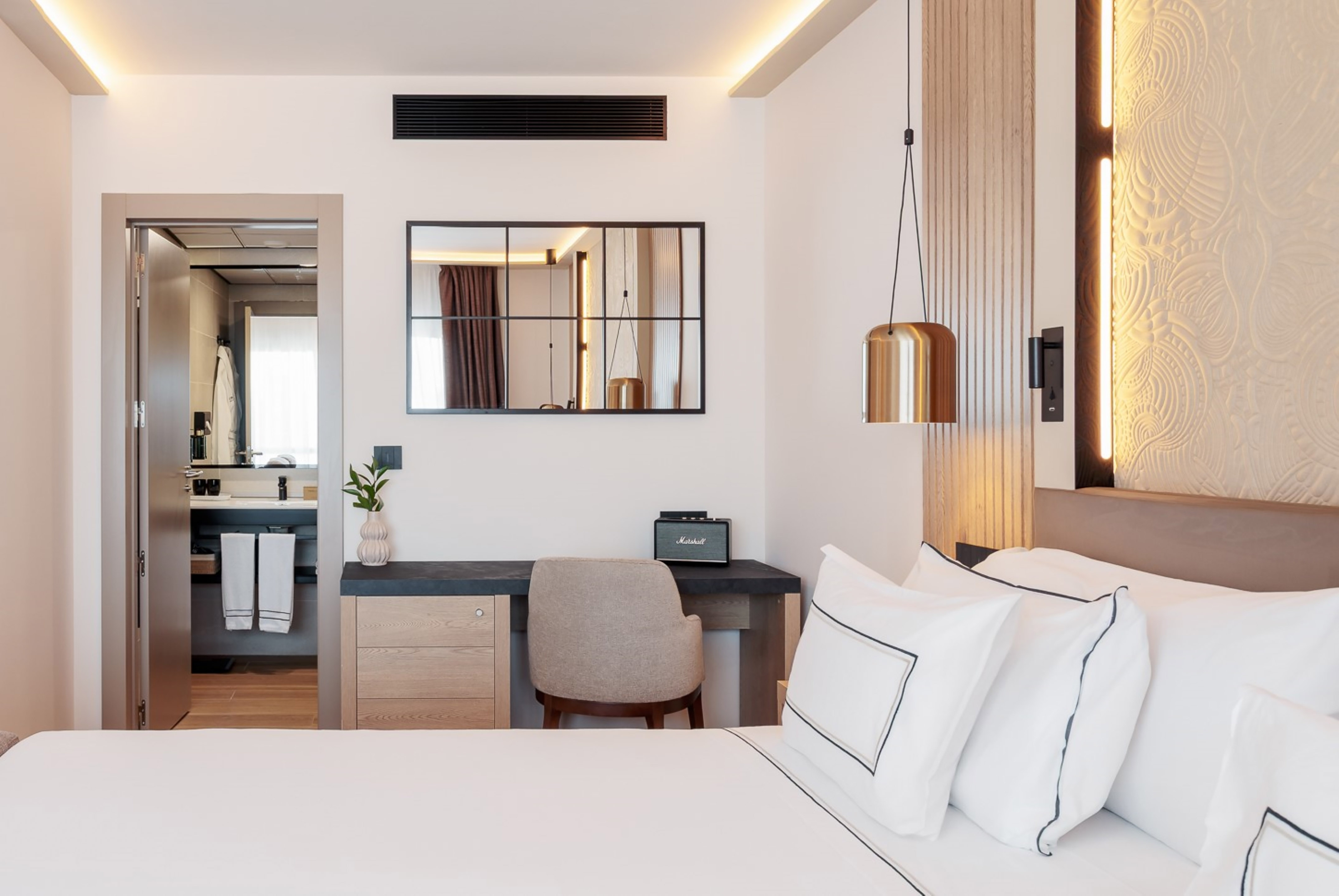 a bedroom with a mirror and a bed