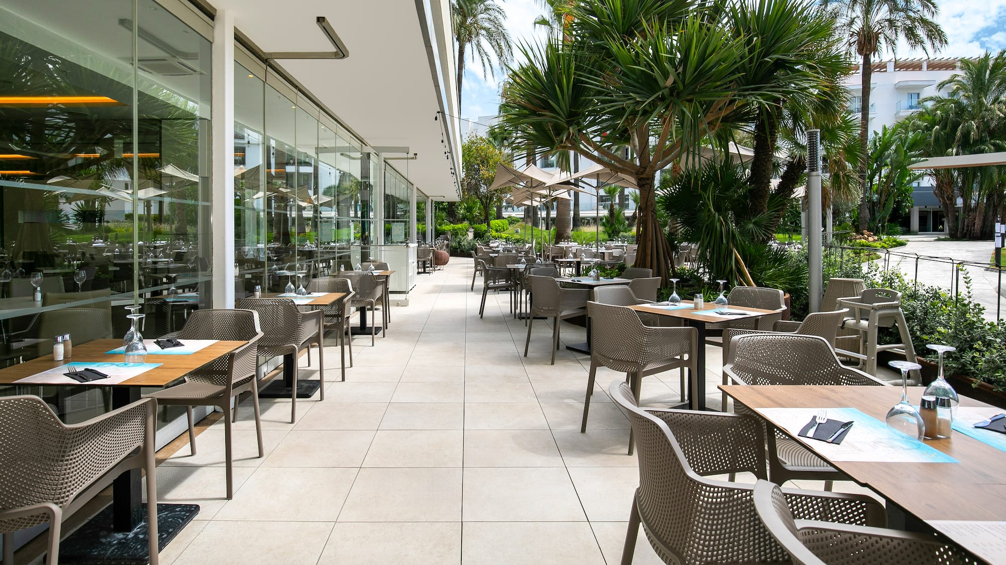 a patio with tables and chairs