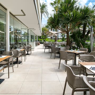 a patio with tables and chairs