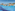 Sunny water park pool with slides, fountains, waterfalls, and blue mosaic tiles.