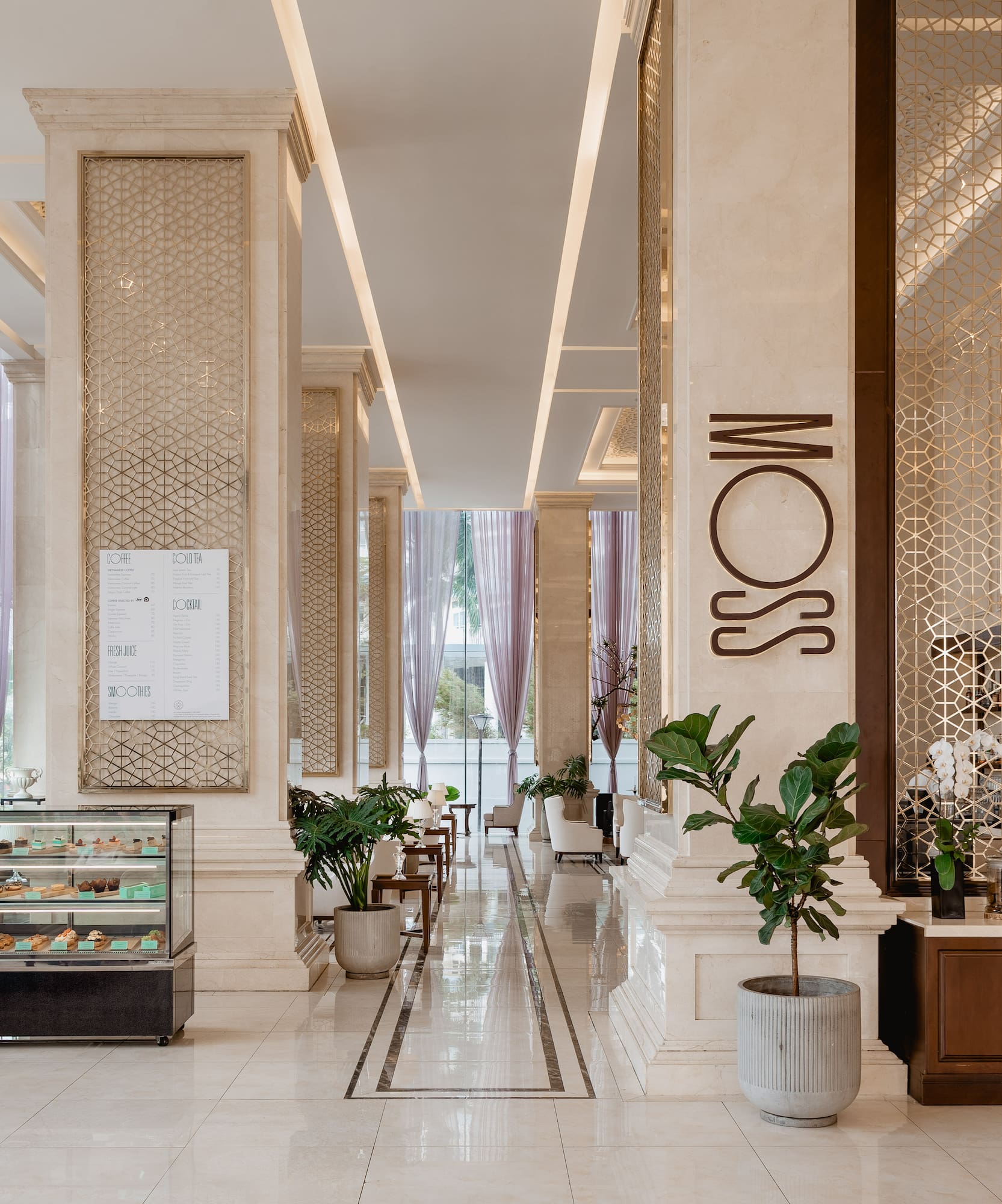 a large hall with columns and a glass case