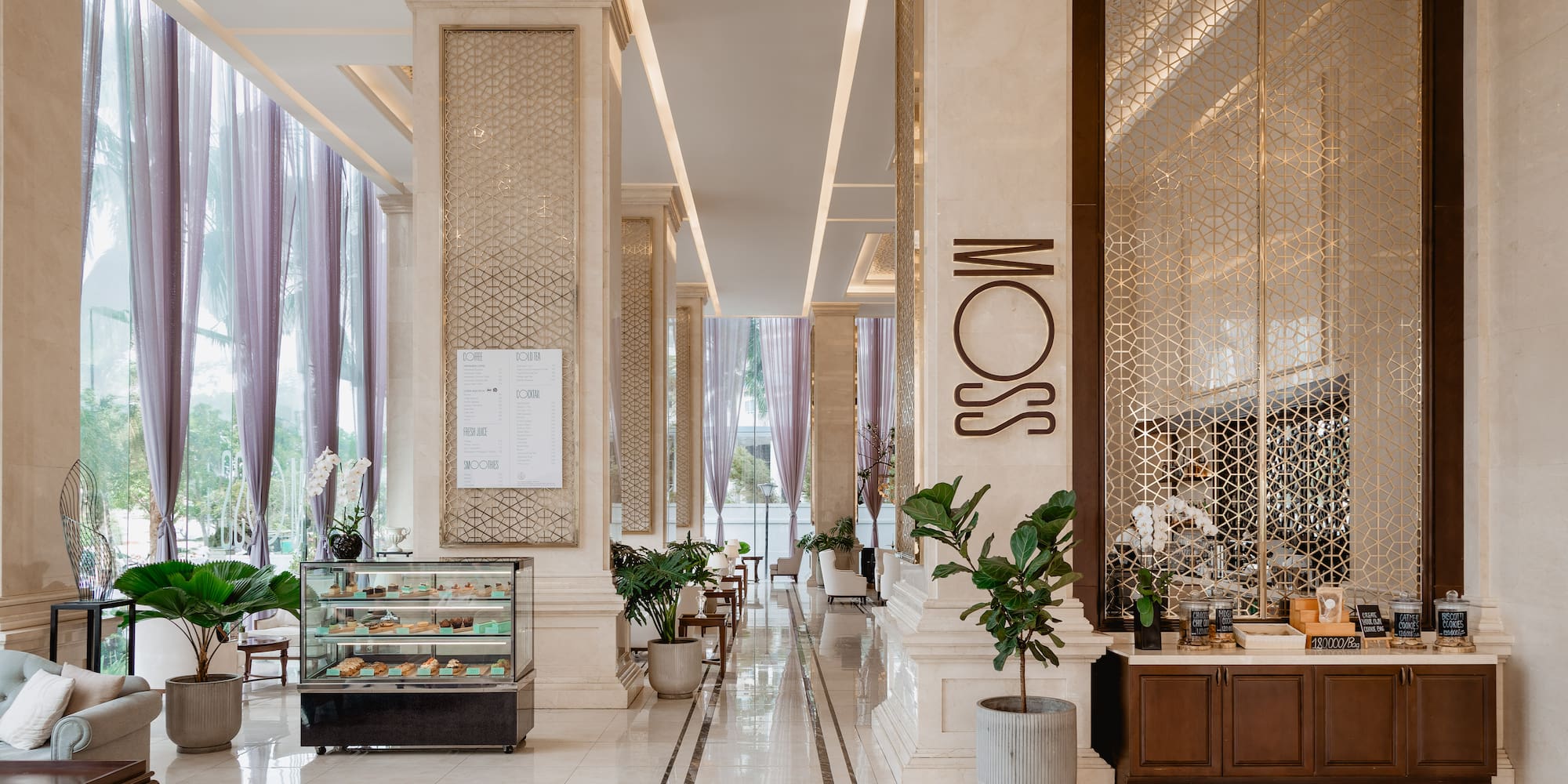 a large hall with columns and a glass case