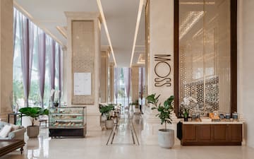 a large hall with columns and a glass case