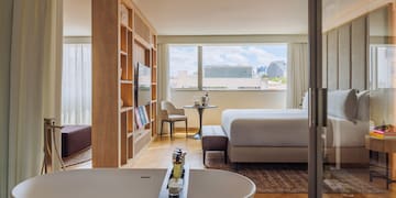 a room with a bed and a bathtub