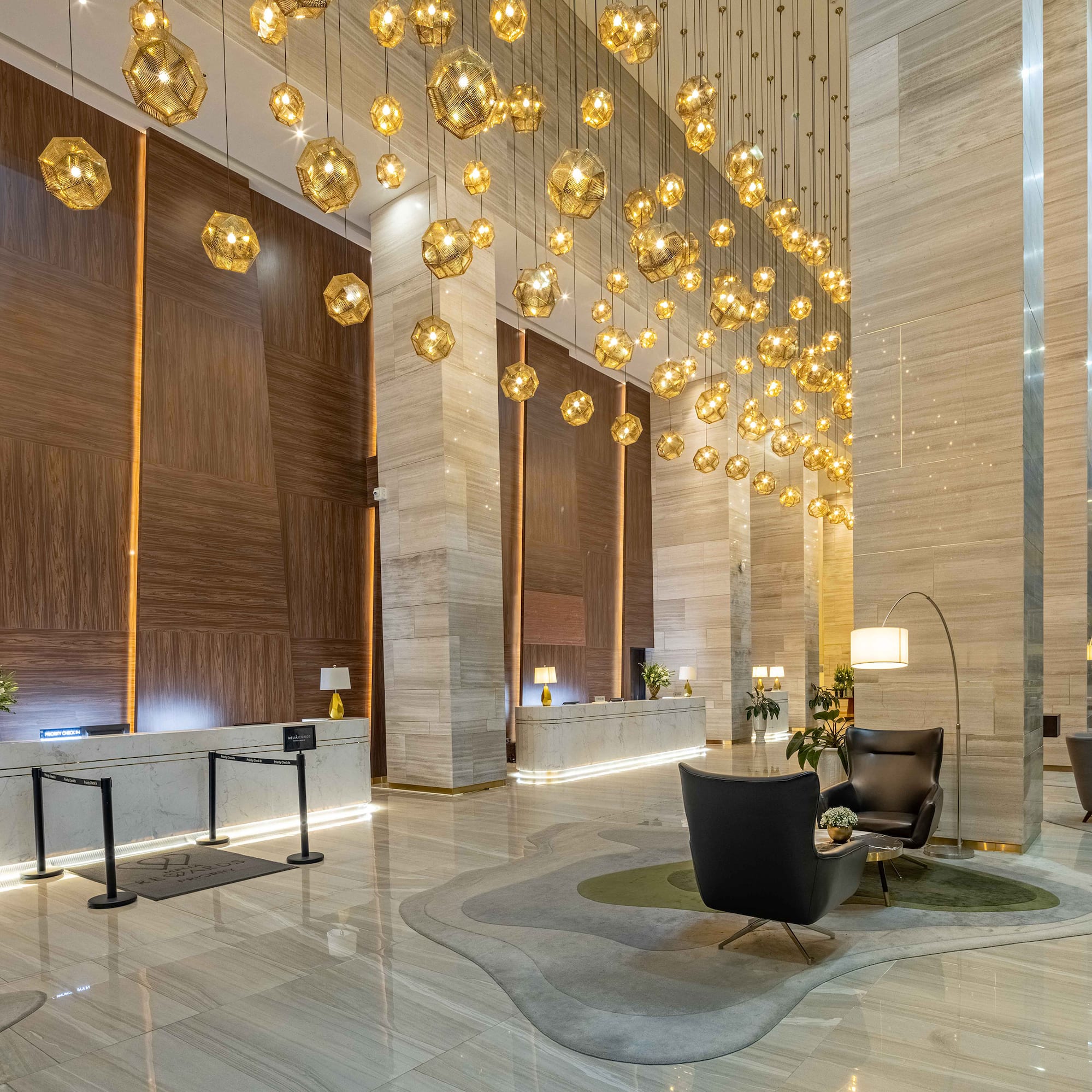 a lobby with a chandelier and chairs