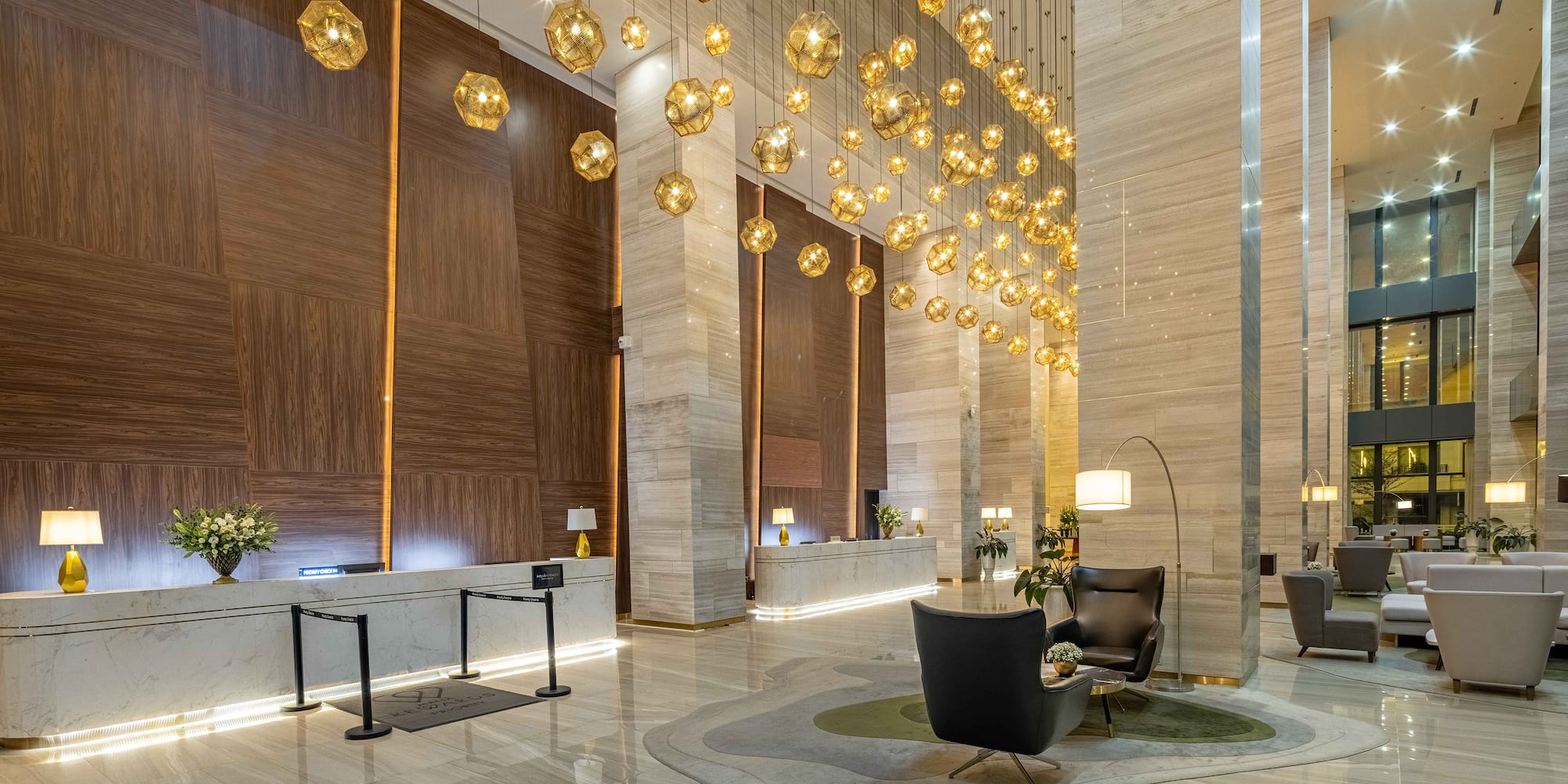 a lobby with a chandelier and chairs