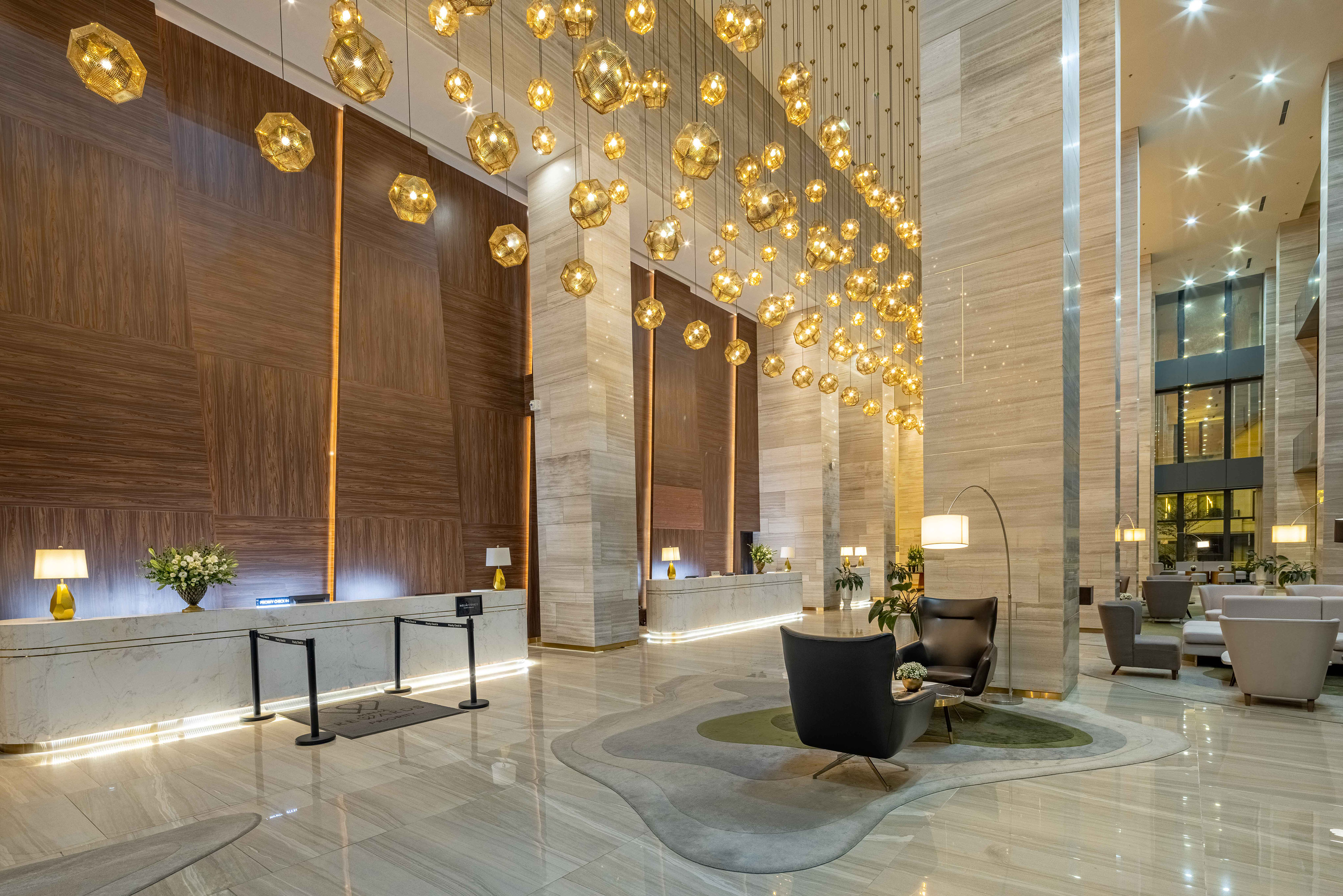 a lobby with a chandelier and chairs