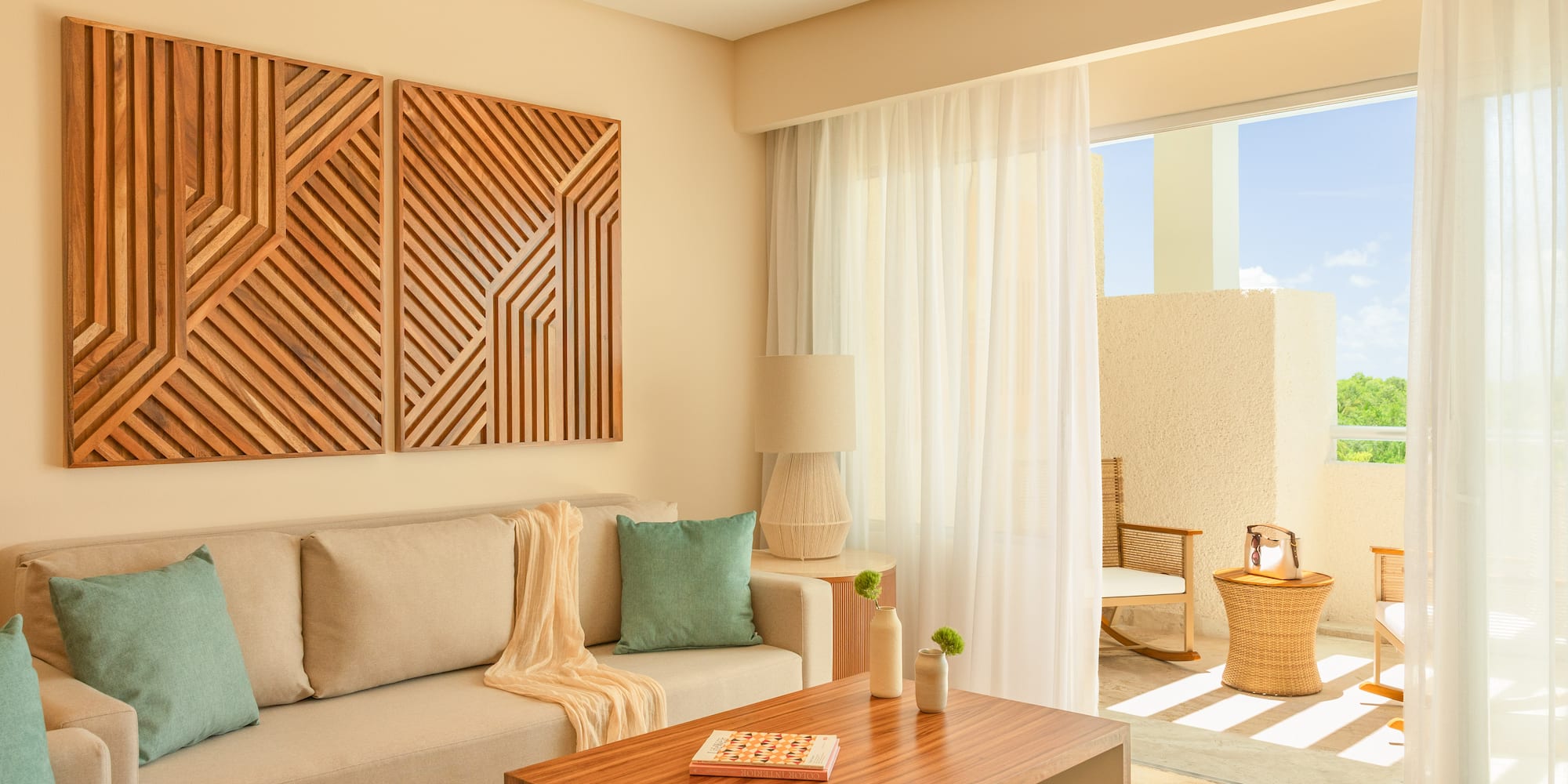 Modern living room with beige sofa, geometric wood art, and bright balcony.