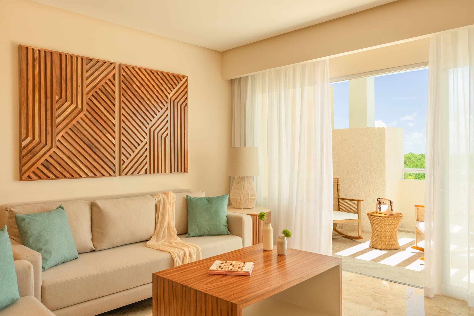 Modern living room with beige sofa, geometric wood art, and bright balcony.