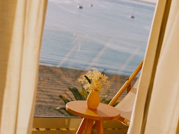 a table with flowers on it by a window