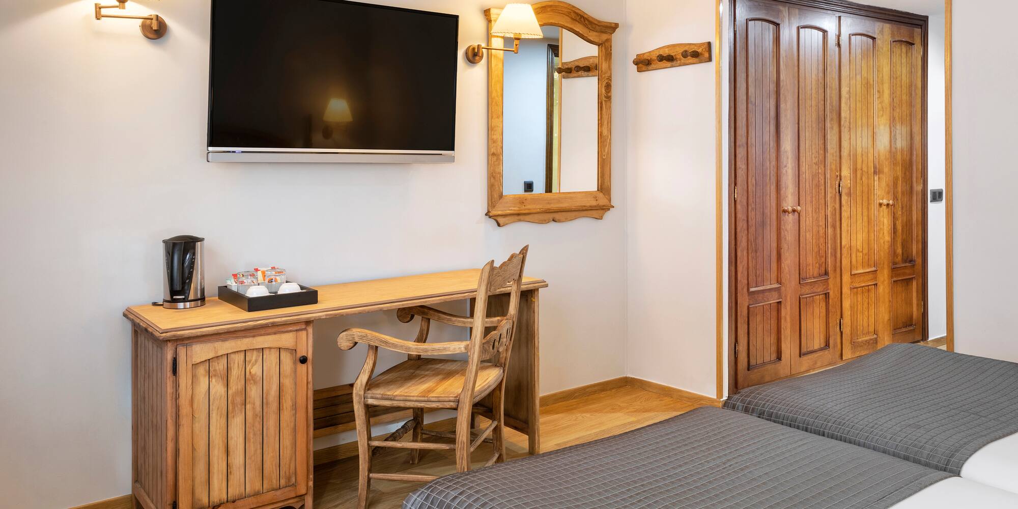 a room with a bed and a television