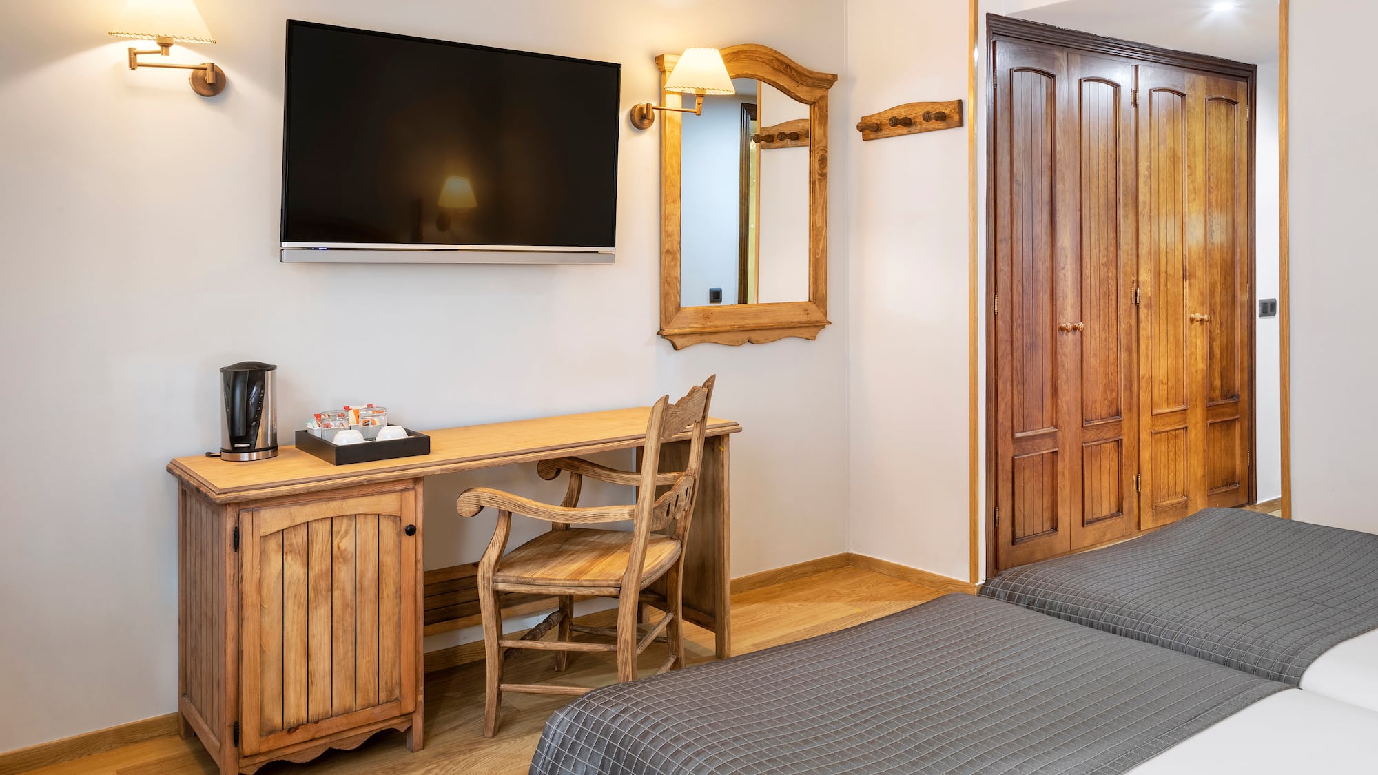 a room with a bed and a television