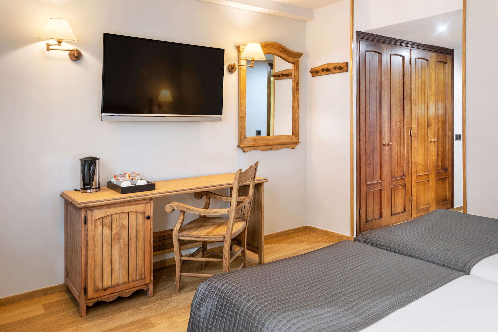 a room with a bed and a television