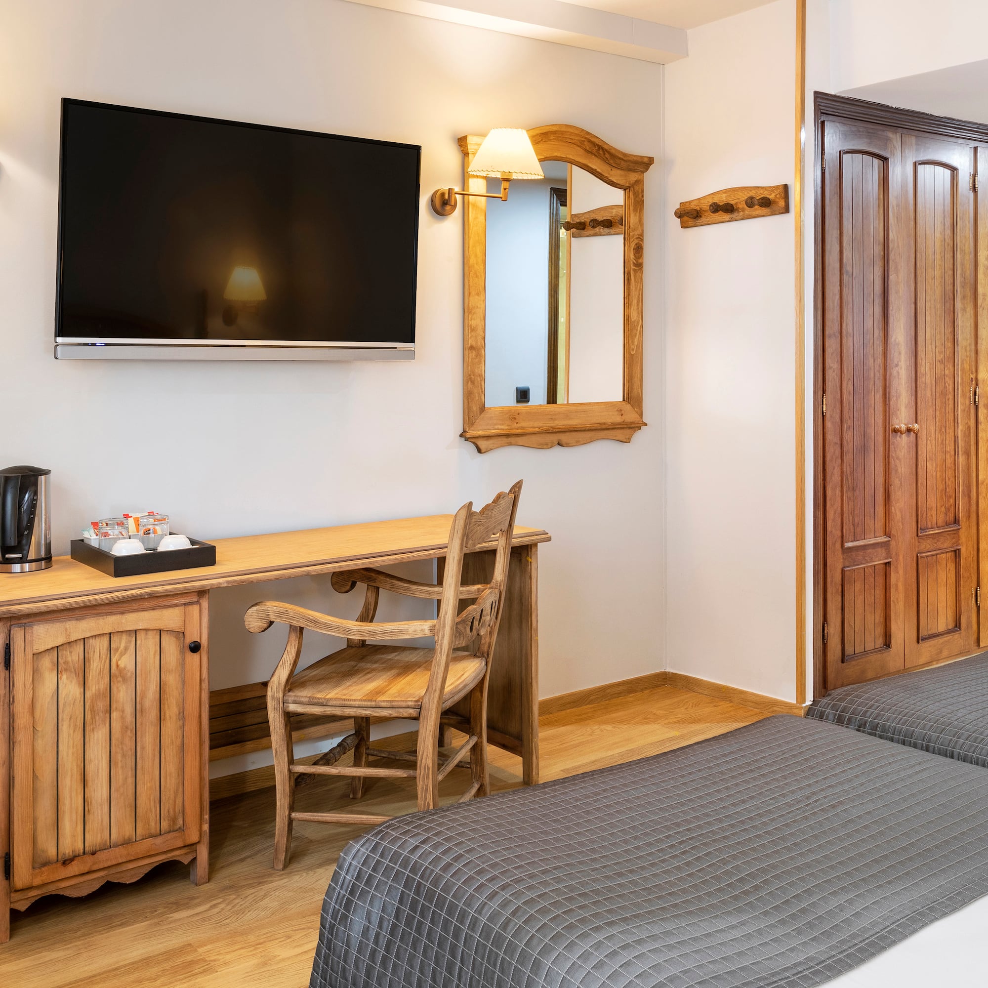 a room with a bed and a television