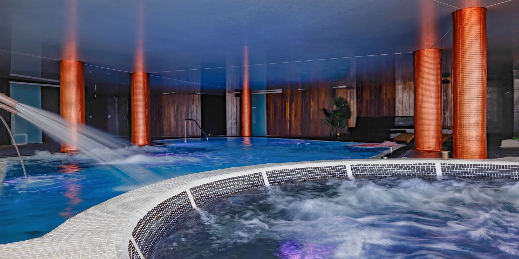 a large indoor jacuzzi with a hot tub