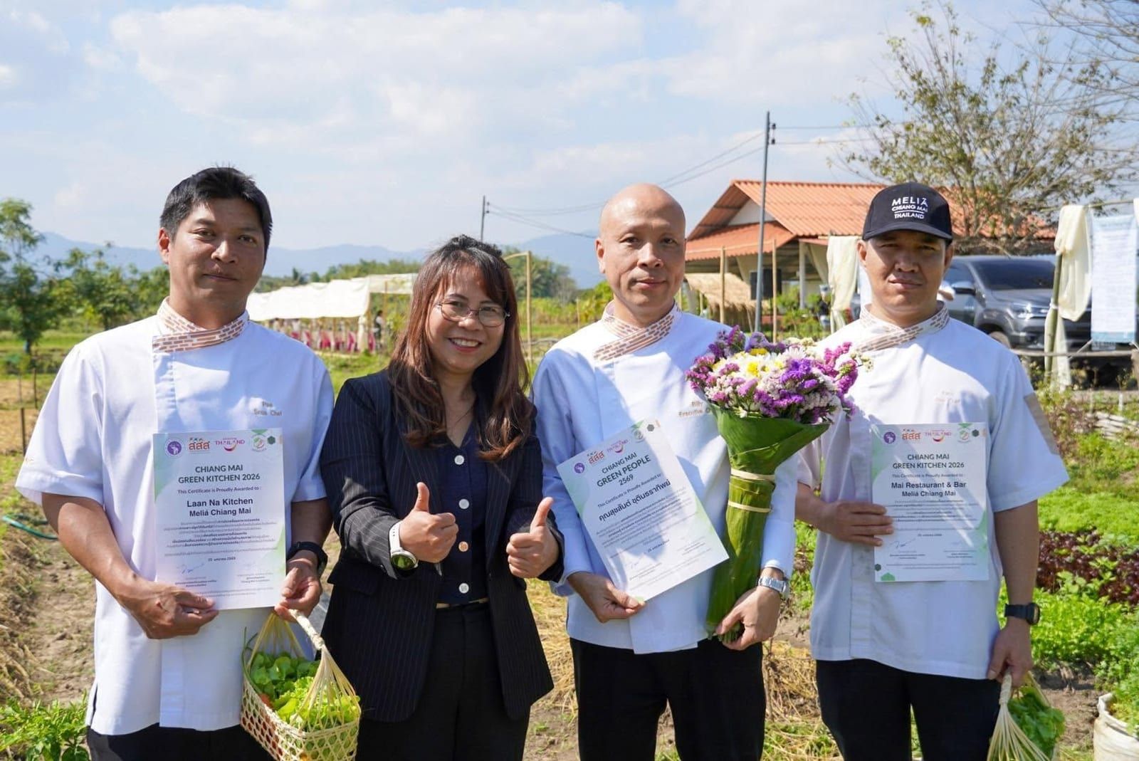 Melia Chiang Mai chefs celebrating Green Kitchen awards with fresh produce.