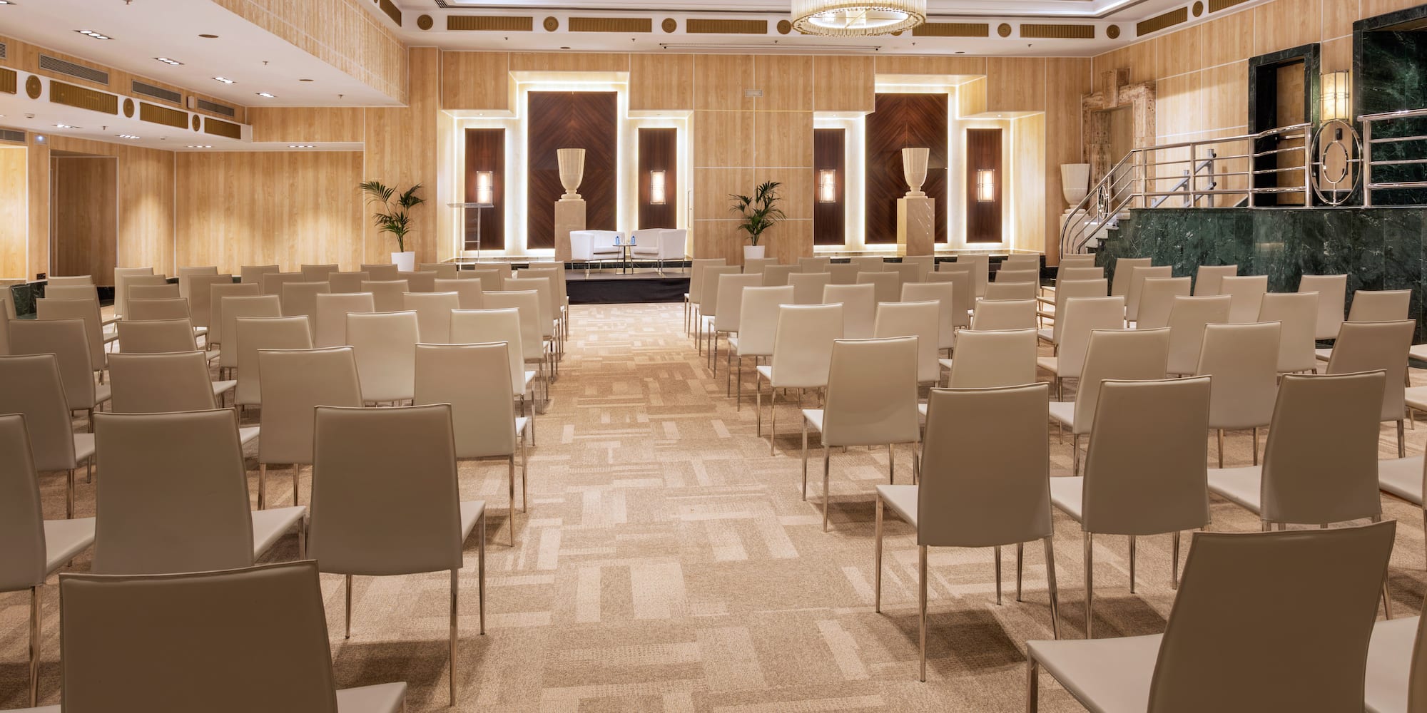 a room with chairs and a chandelier