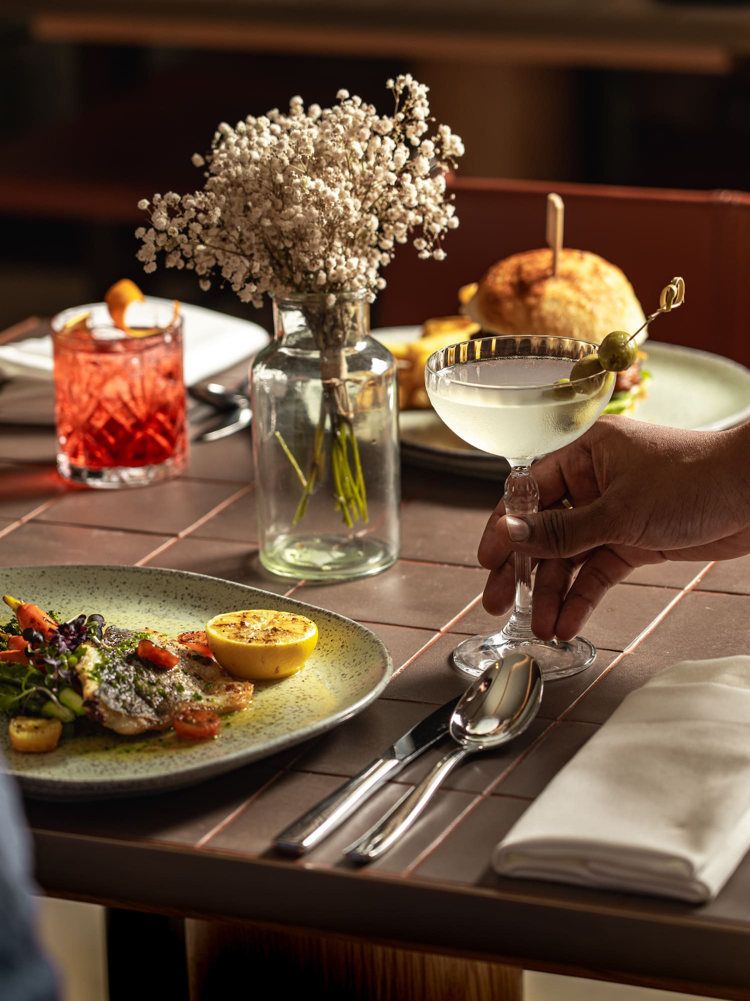 a hand holding a glass of liquid