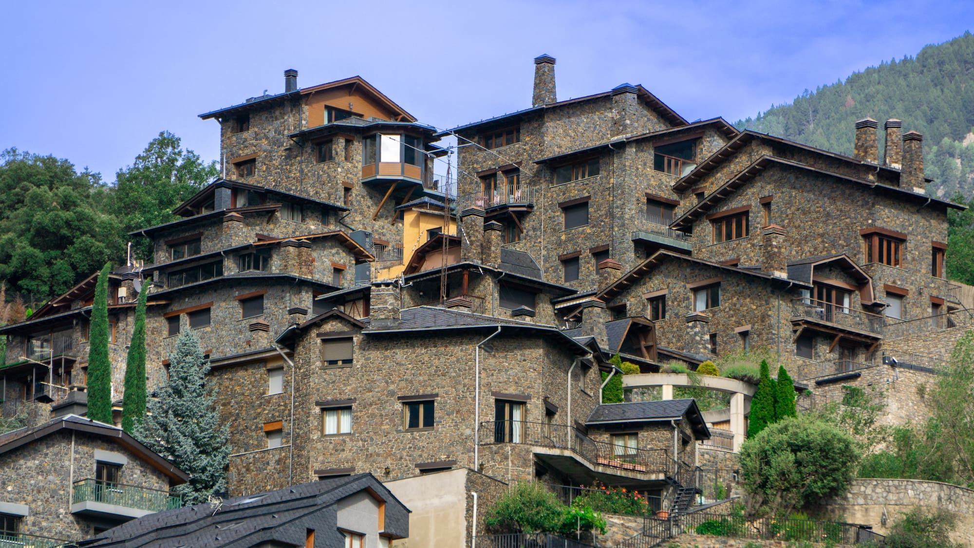 a group of houses on a hill with Chora Church in the background