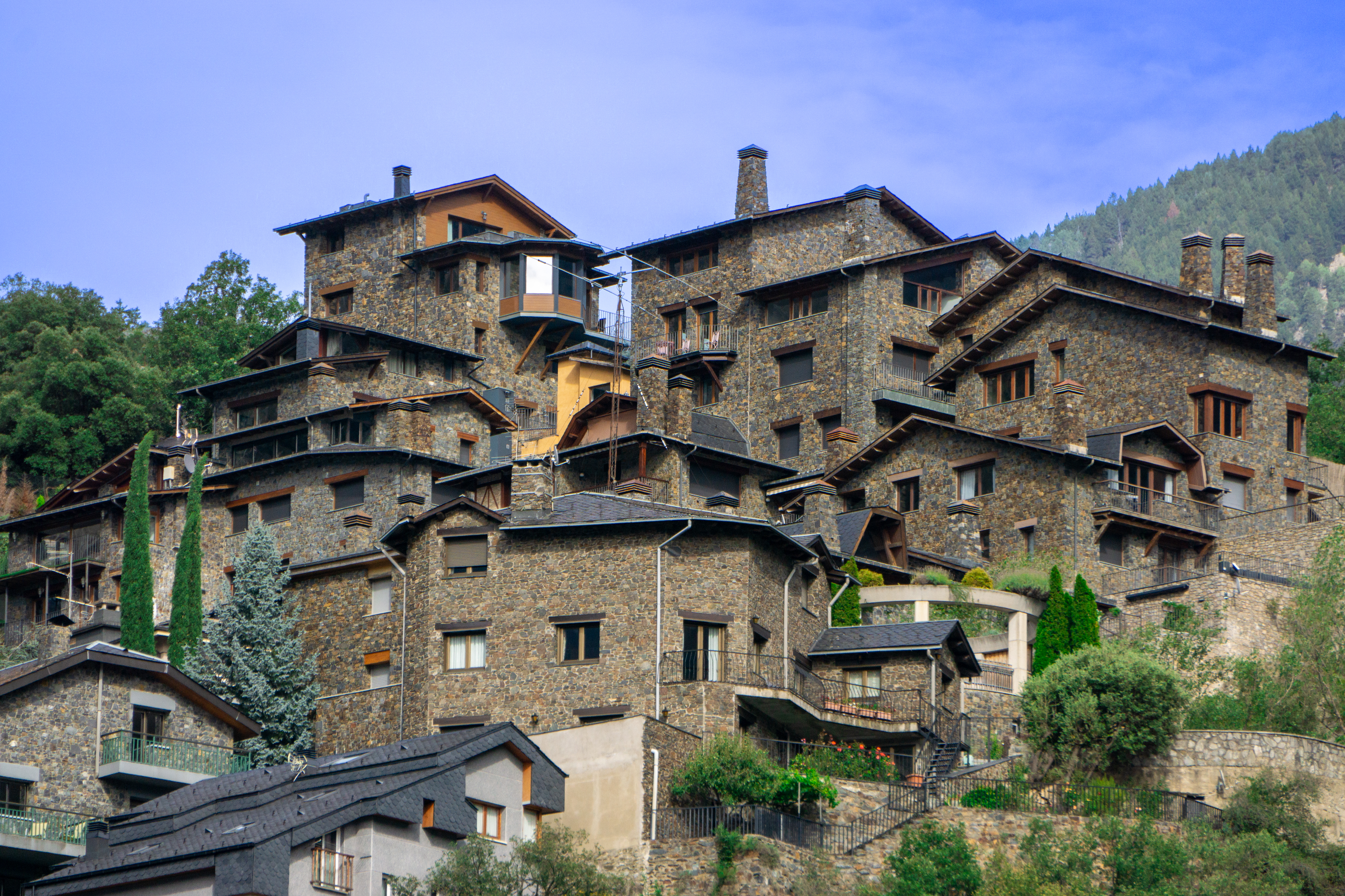 a group of houses on a hill with Chora Church in the background