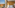 Modern hotel room with comfortable bed and scenic city garden view.