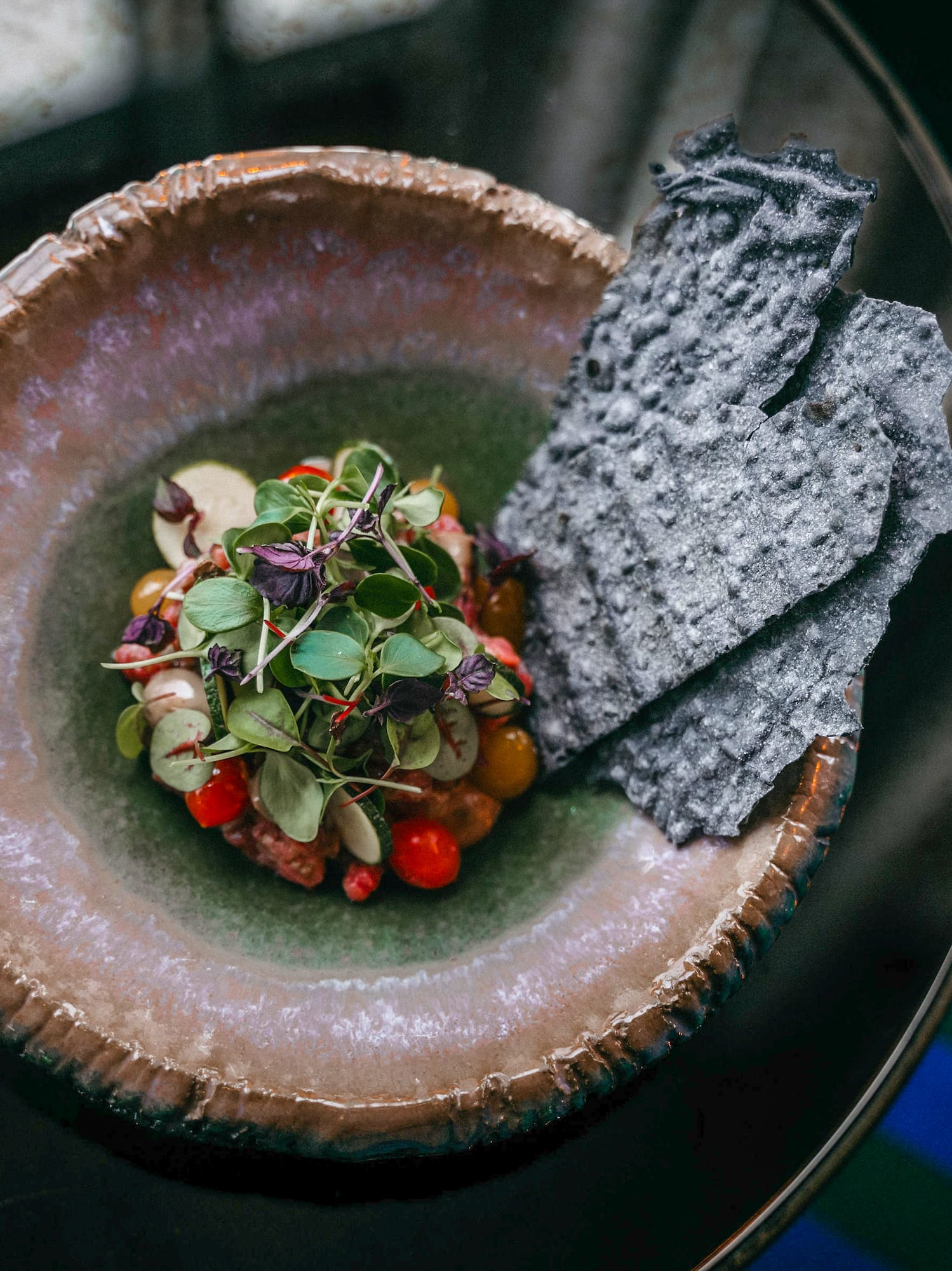 a plate of food on a glass table