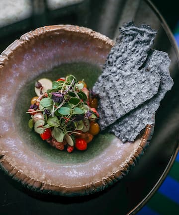 a plate of food on a glass table