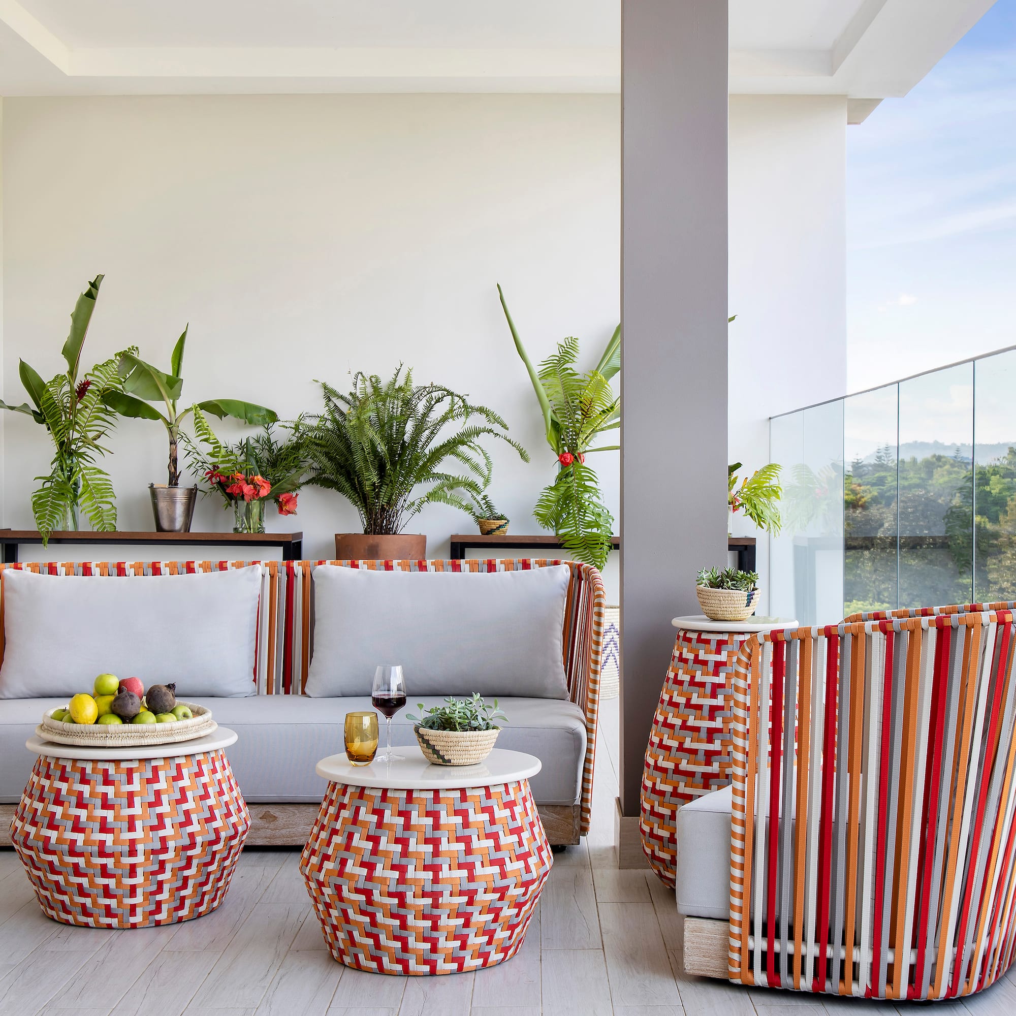 a patio with a couch and chairs