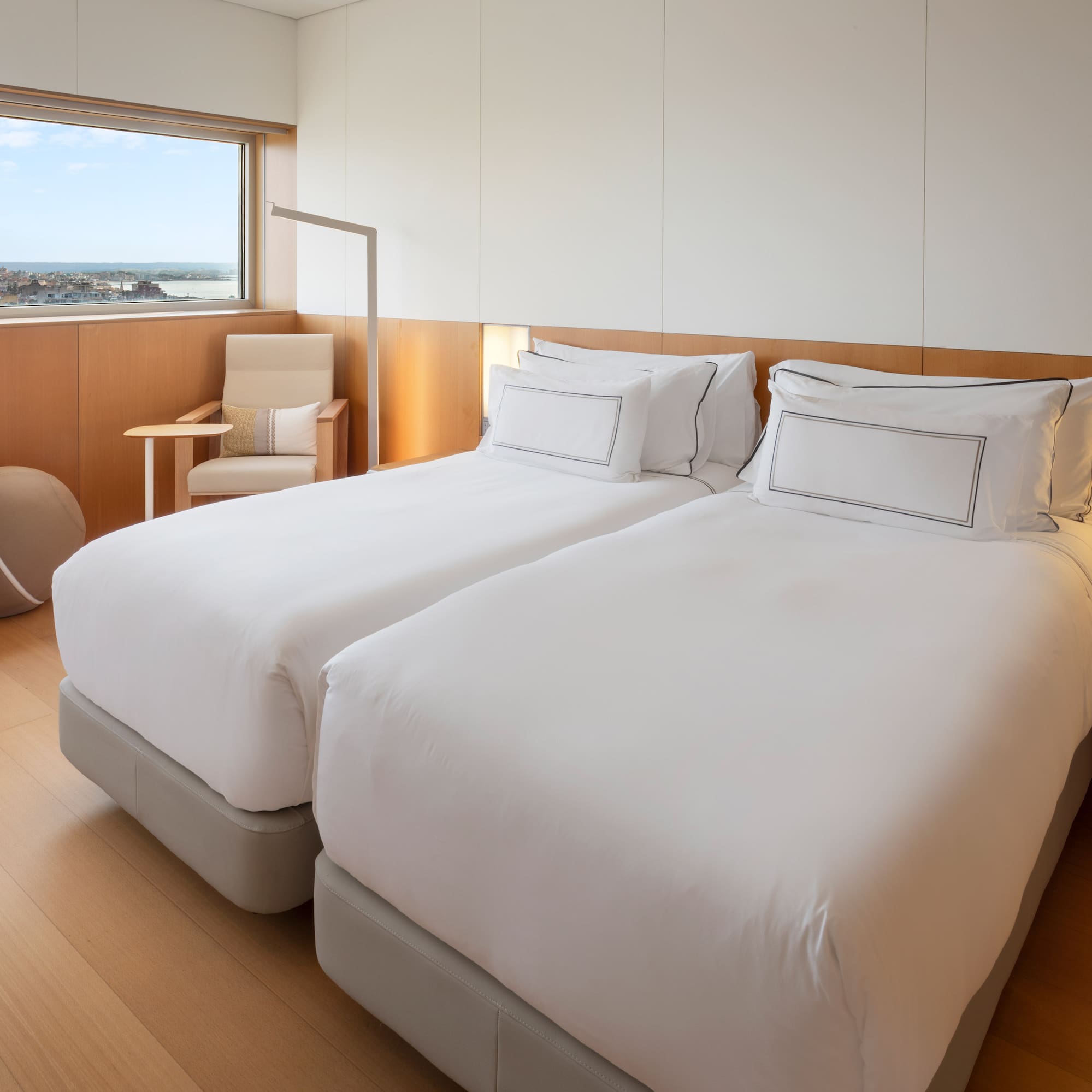 a room with two beds and a window