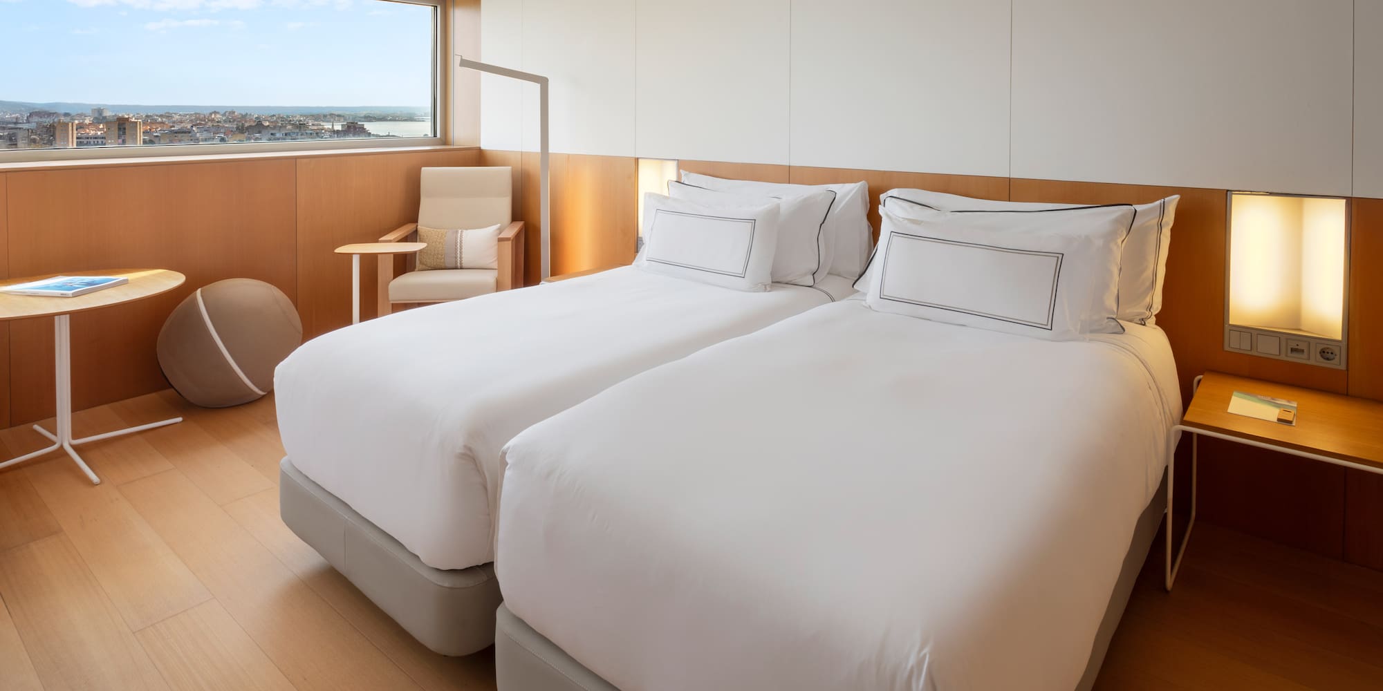 a room with two beds and a window