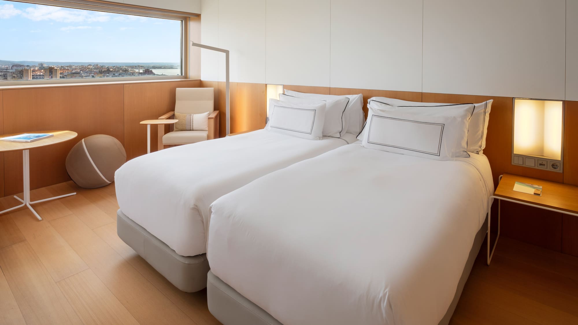 a room with two beds and a window