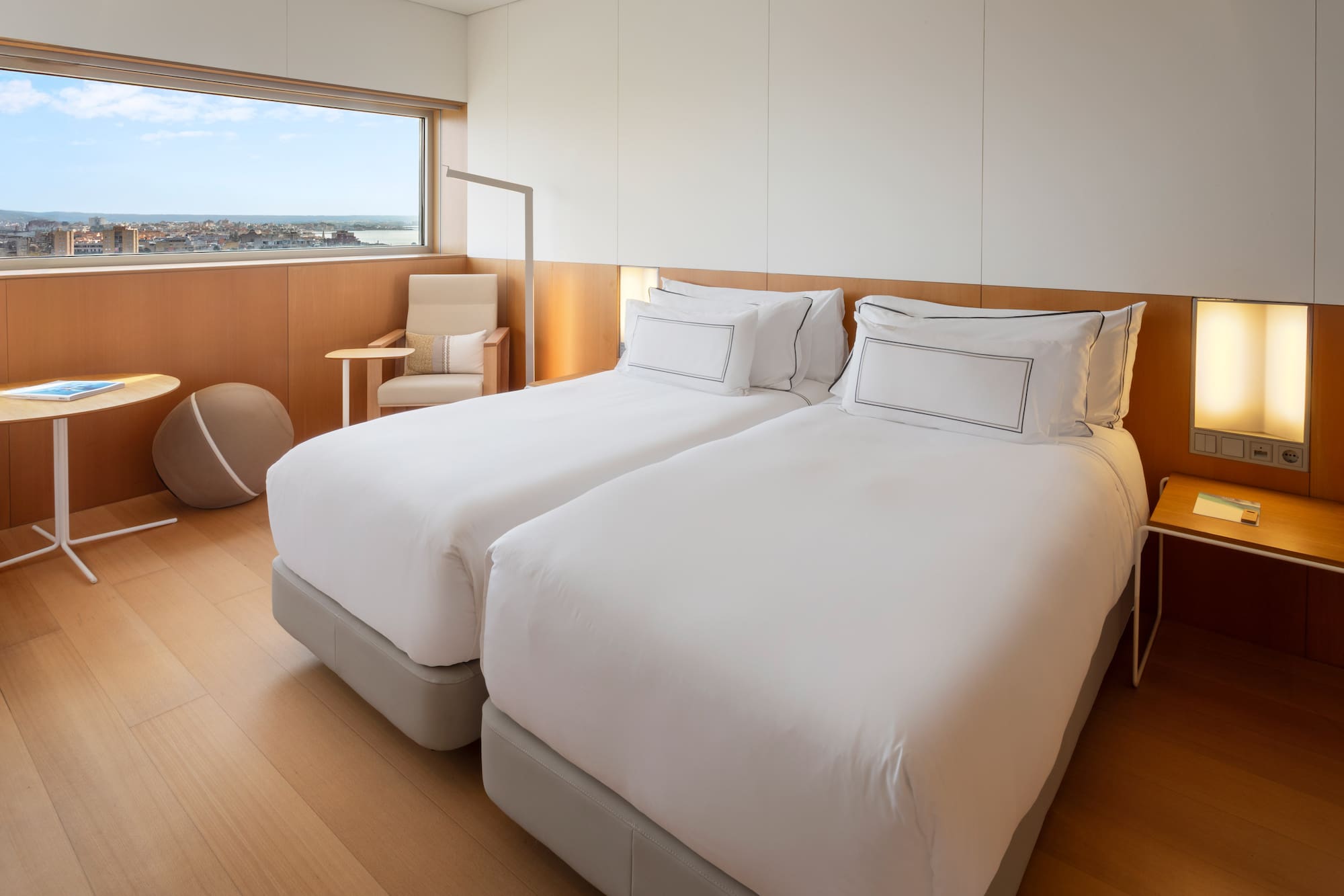 a room with two beds and a window