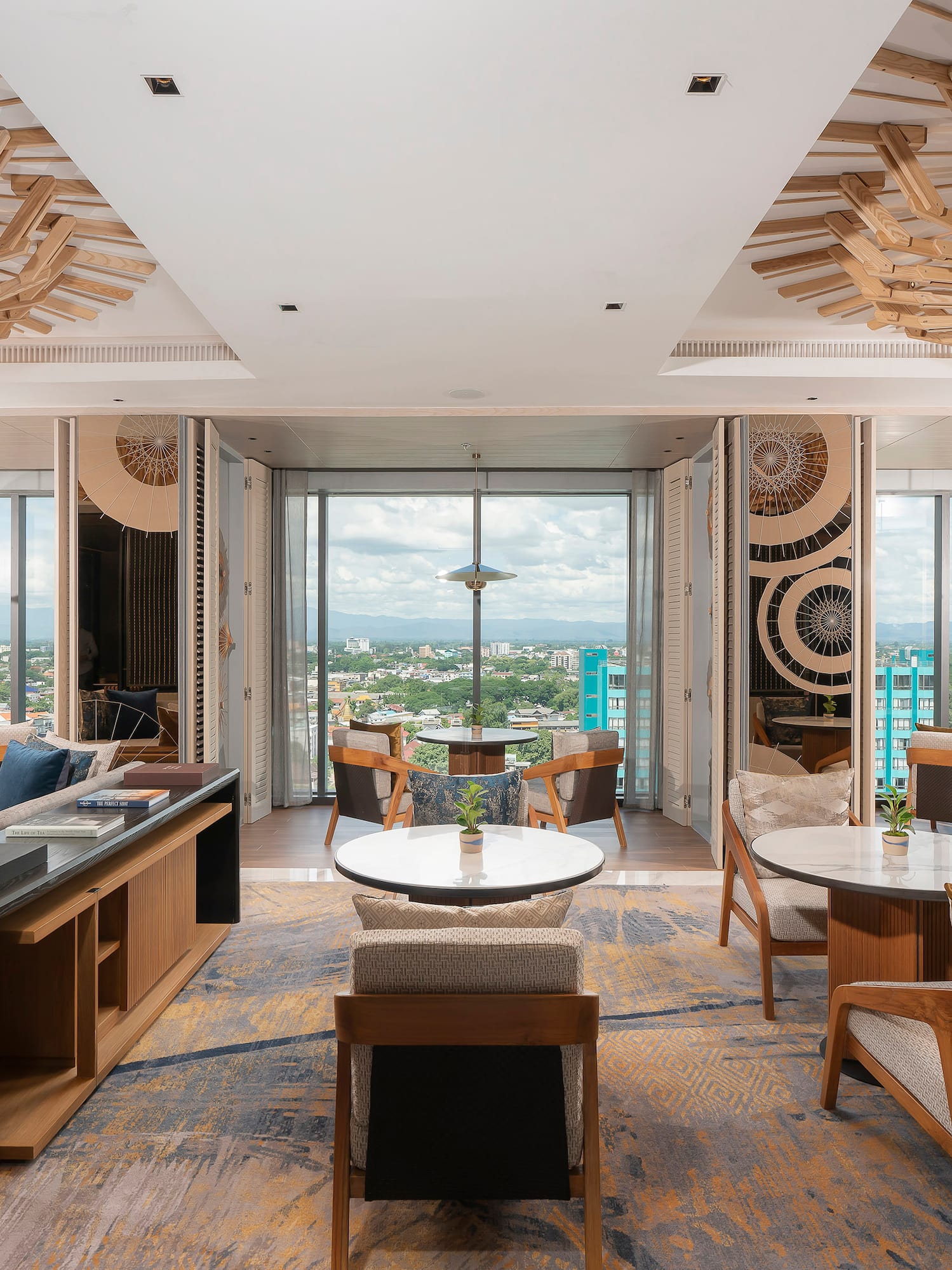 a room with tables and chairs and a view of a city