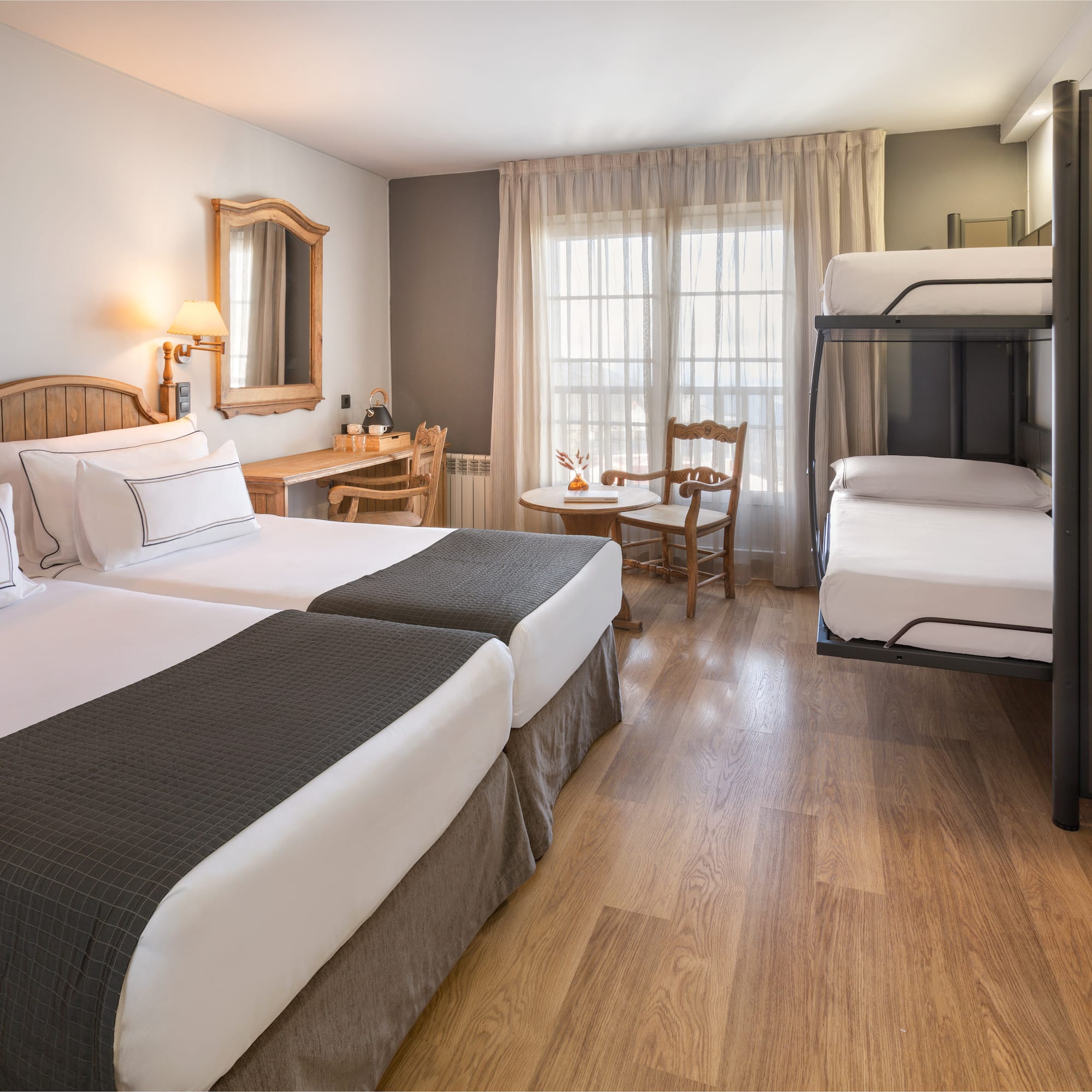 a room with two bunk beds and a table