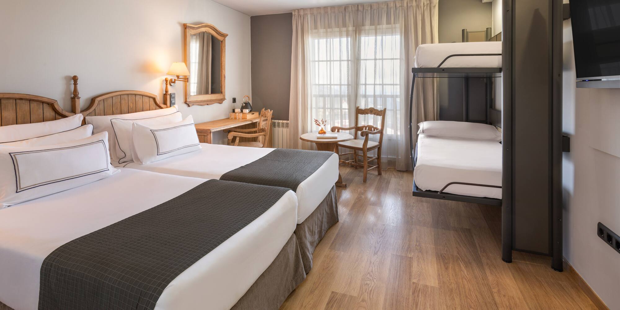 a room with two bunk beds and a table