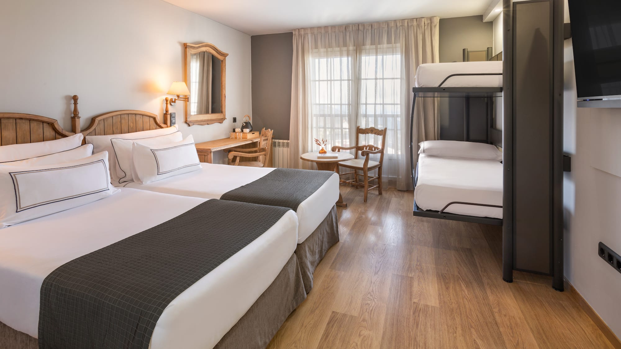 a room with two bunk beds and a table