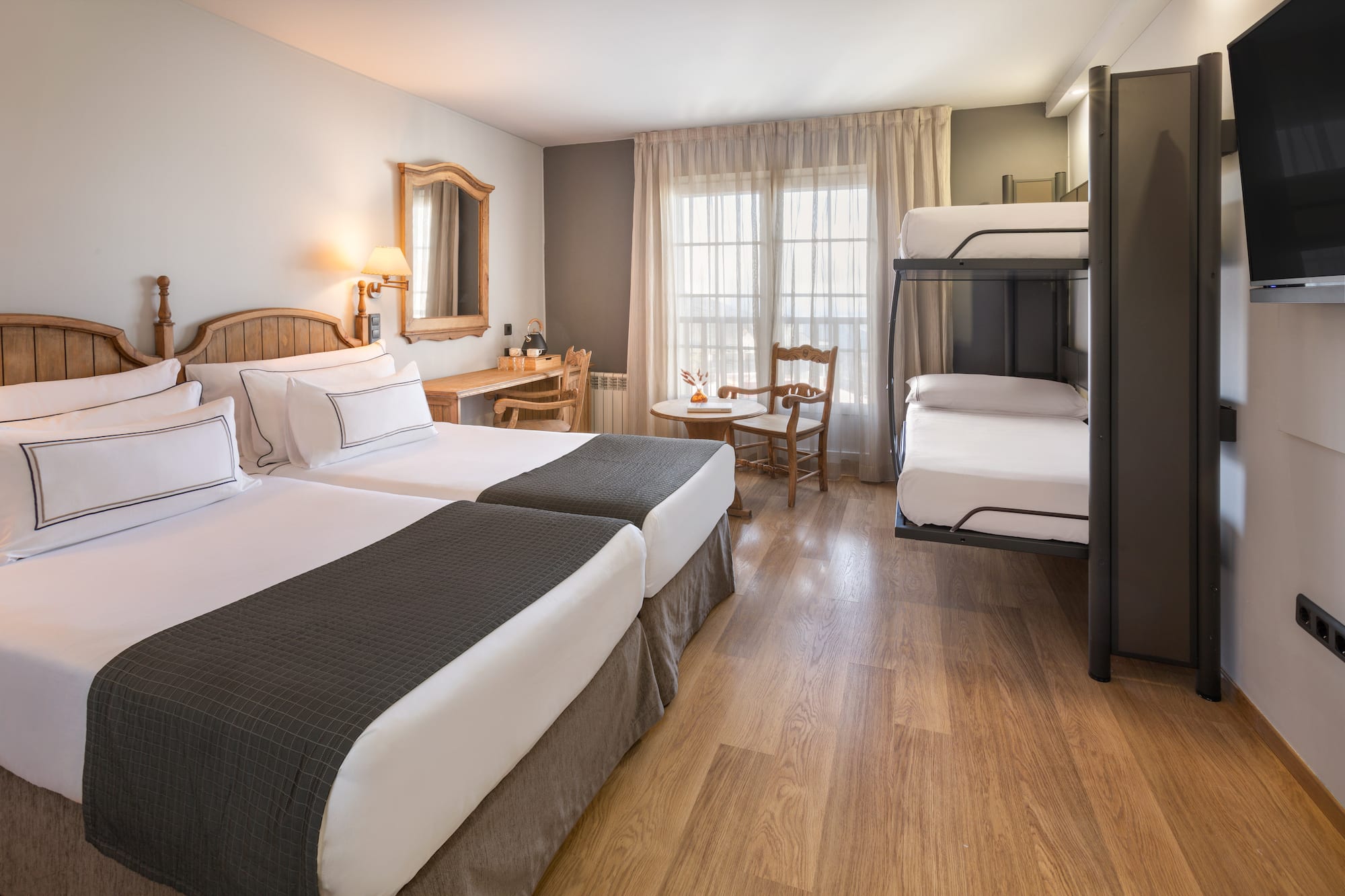 a room with two bunk beds and a table