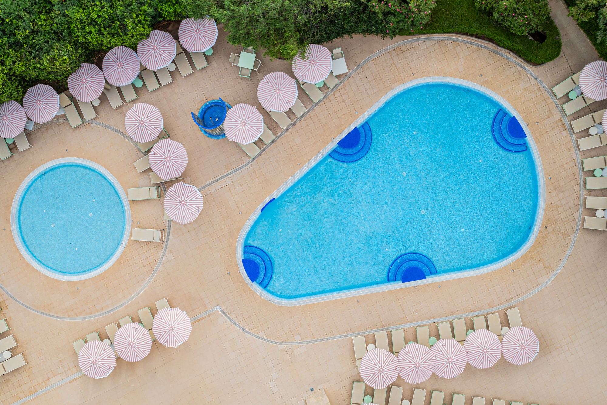 a pool with umbrellas and chairs