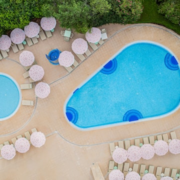 a pool with umbrellas and chairs