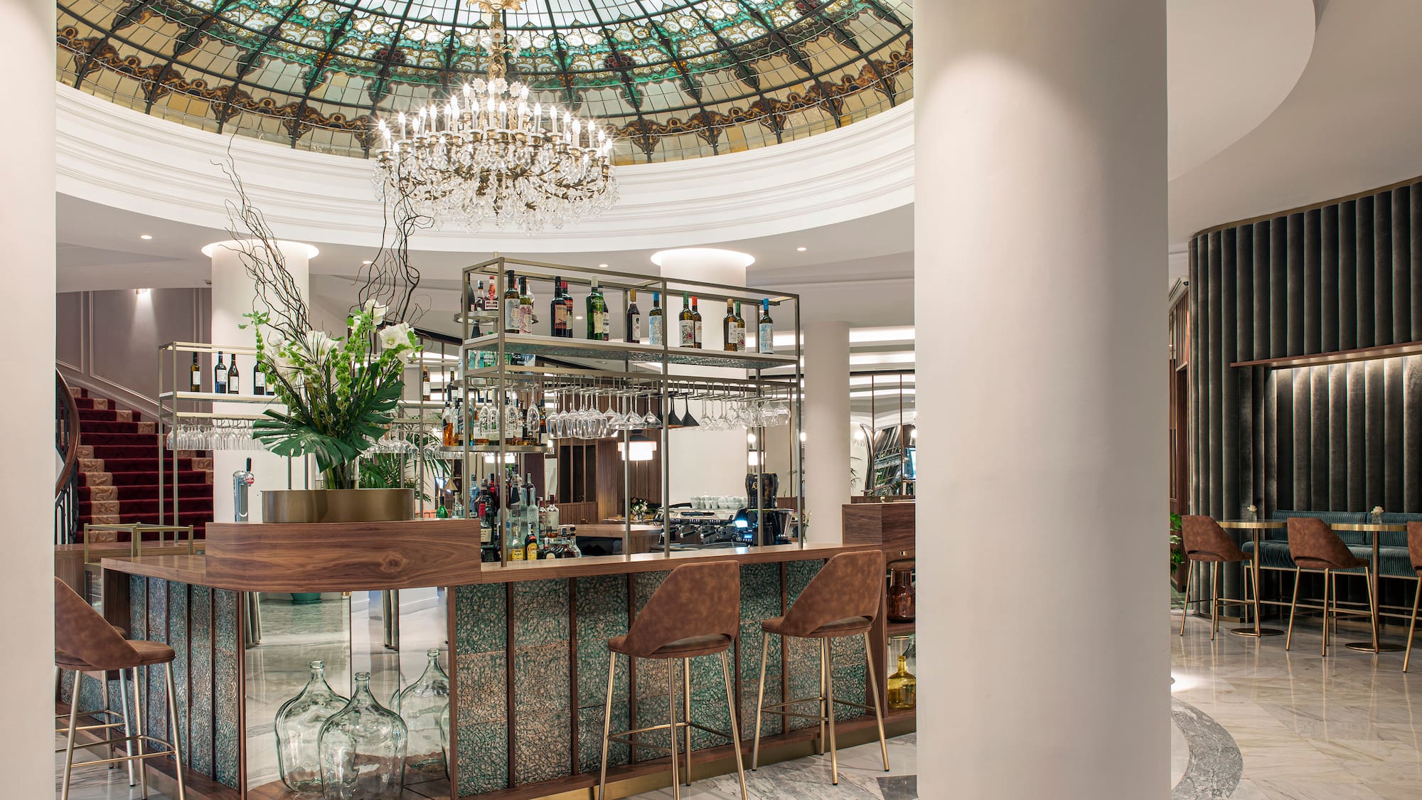 a bar with a glass ceiling and a chandelier