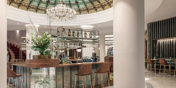 a bar with a glass ceiling and a chandelier