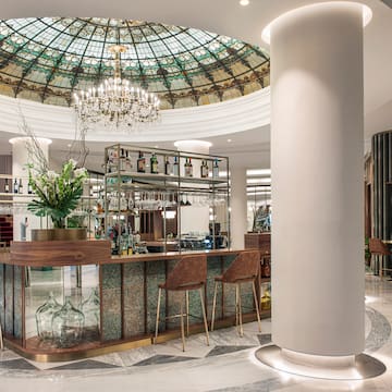 a bar with a glass ceiling and a chandelier